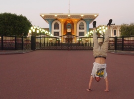 Adam does a handstand in front of Al Alam Palace